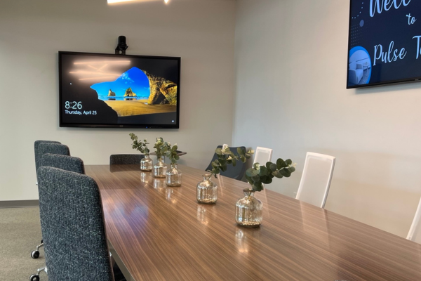 A video display and webcam in a conference room.