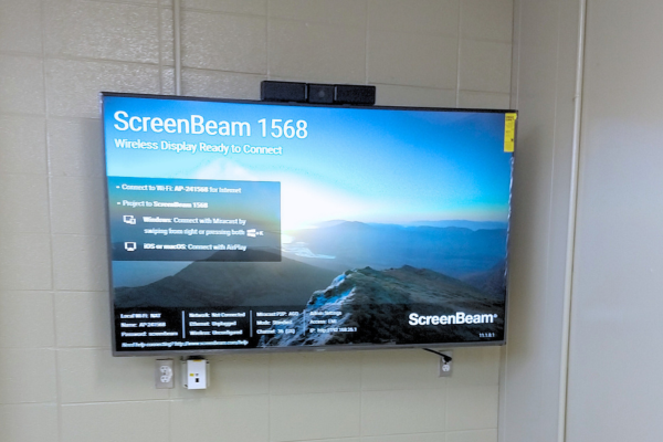 A video display on a cement wall.