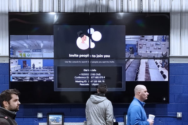 Four professional screens put together at a conference.