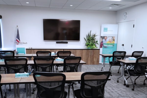 A video display hanging on a wall in a meeting room.