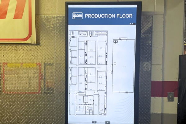 A vertical video display with a floor plan on it.