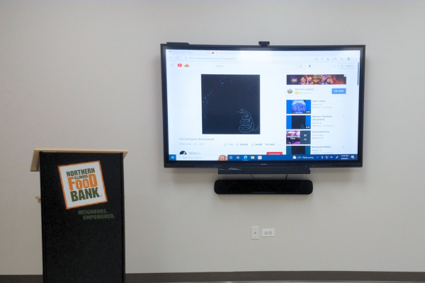 A video display on a wall next to a podium.