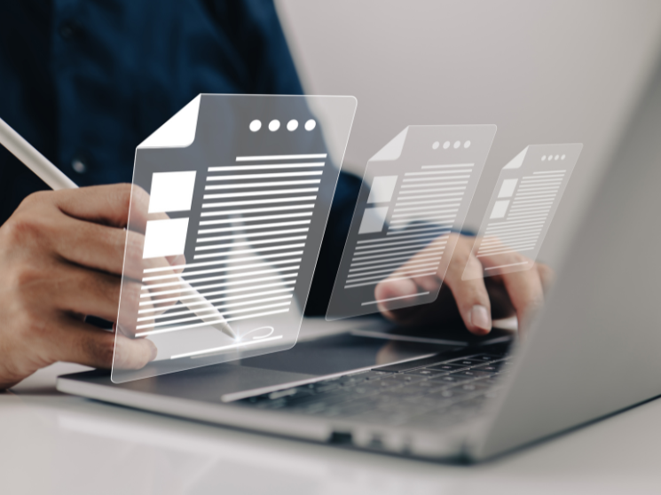 A person digitally signing digital documents on their laptop.