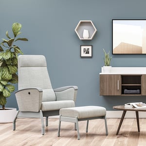 A chair and footrest in a modern room.