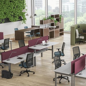 An open floorplan office with desks and chairs.