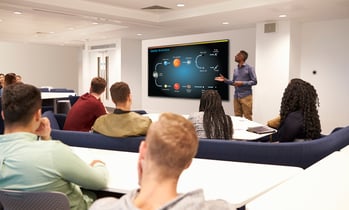 A teacher using a smartboard to teach a science class.