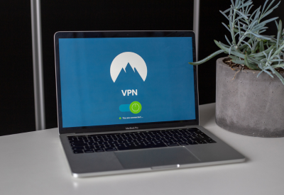 A laptop sitting on a desk that shows it is connected to a VPN