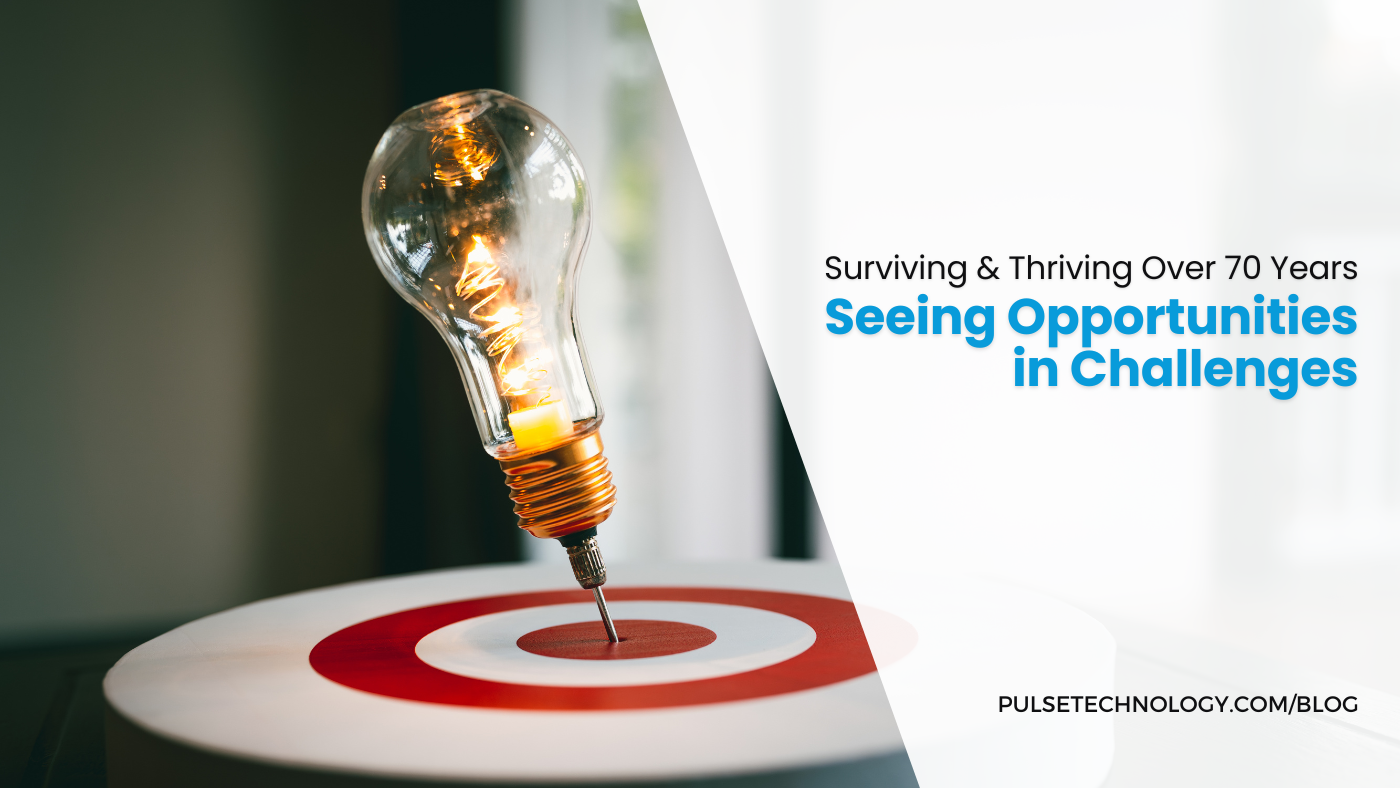 A dart in the center of a bullseye. The dart looks like a lit up lightbulb. Text: Surviving and thriving over 70 years. Seeing Opportunities in Challenges