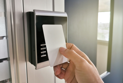 A person using a security card to access a door.