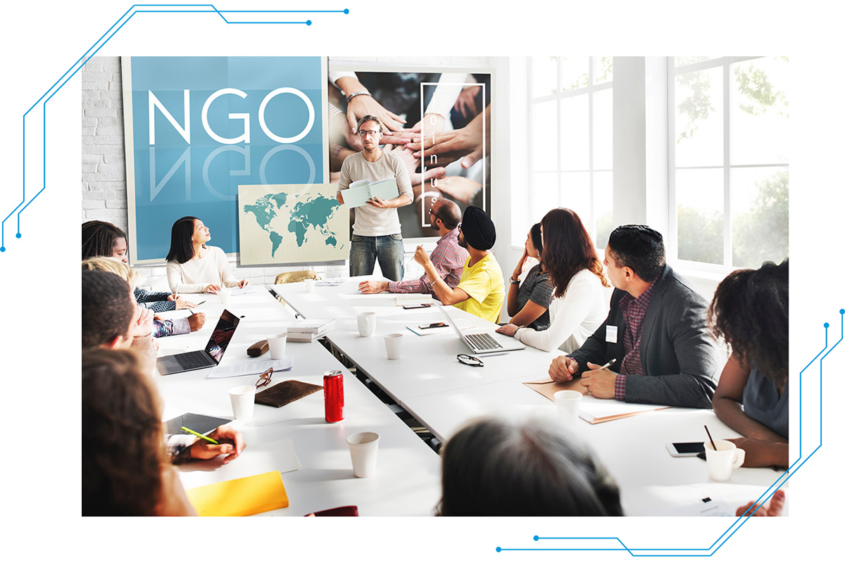 A group of people in a conference room listening to a speaker.