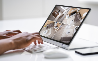 A person on a tablet looking at four feeds of a surveillance system.