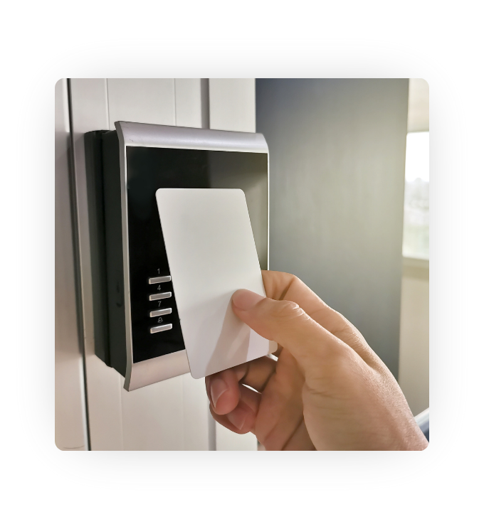 A person using a card to open a locked door.