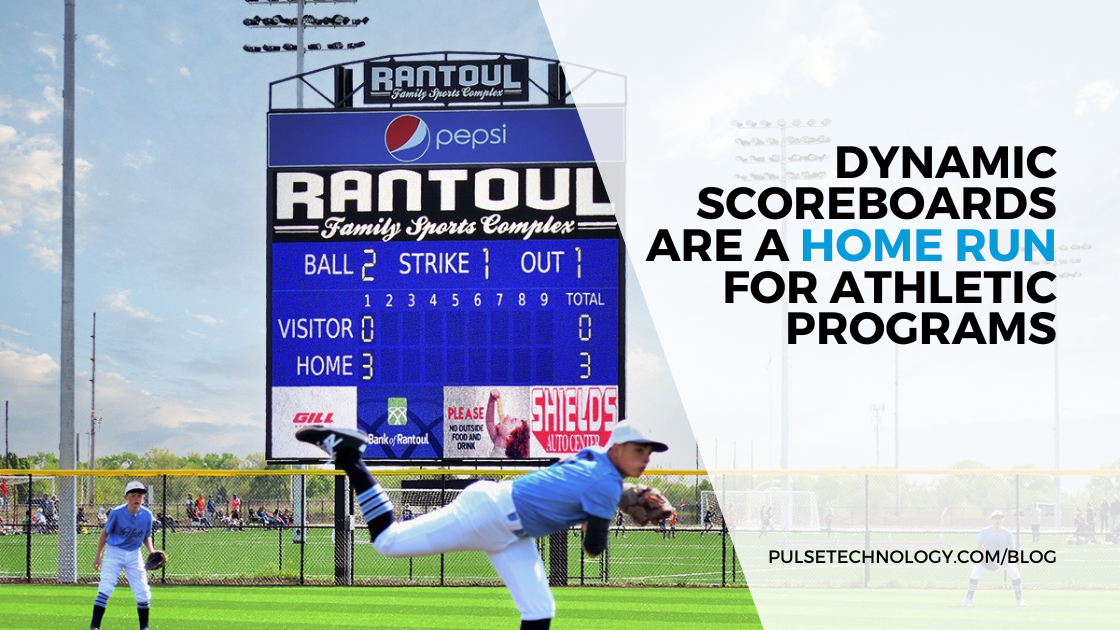 A digital scoreboard at a baseball field with baseball players playing a game.